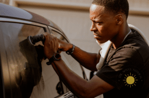 Owner professionally polishing a car during a System X ceramic coating service in Springdale, AR